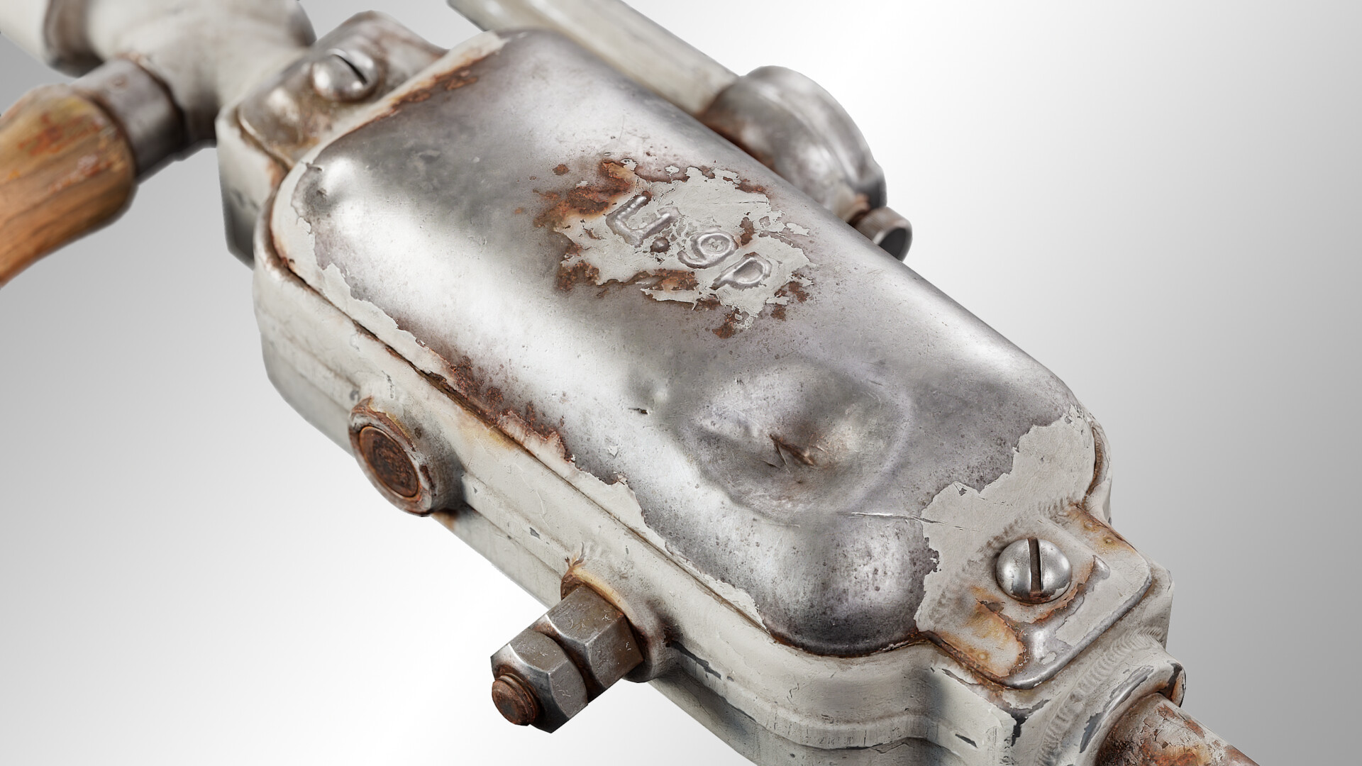 Close-up of a rusty metal device with bolts and screws. "UDP" is visible on its surface, set against a plain gray background.